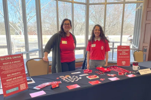 Two members standing at a table